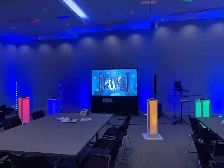 festive office games company game show setup with lighted podiums