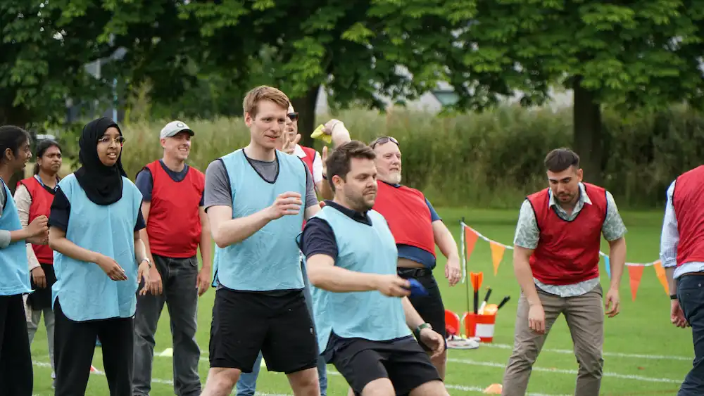 Outdoor Office Olympics people playing bean bag toss