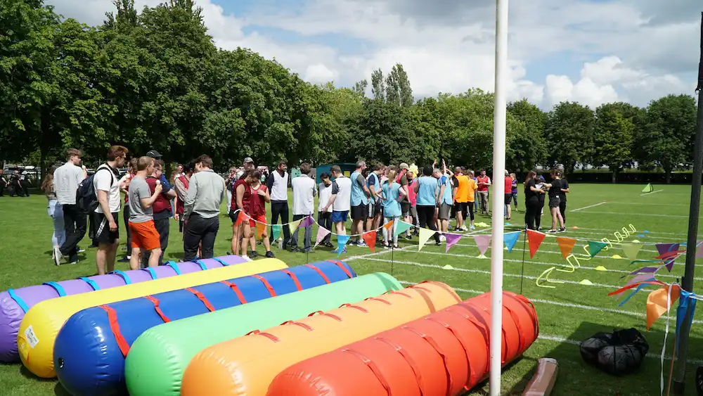 Outdoor Office Olympics crowd of people in game area outdoor team building