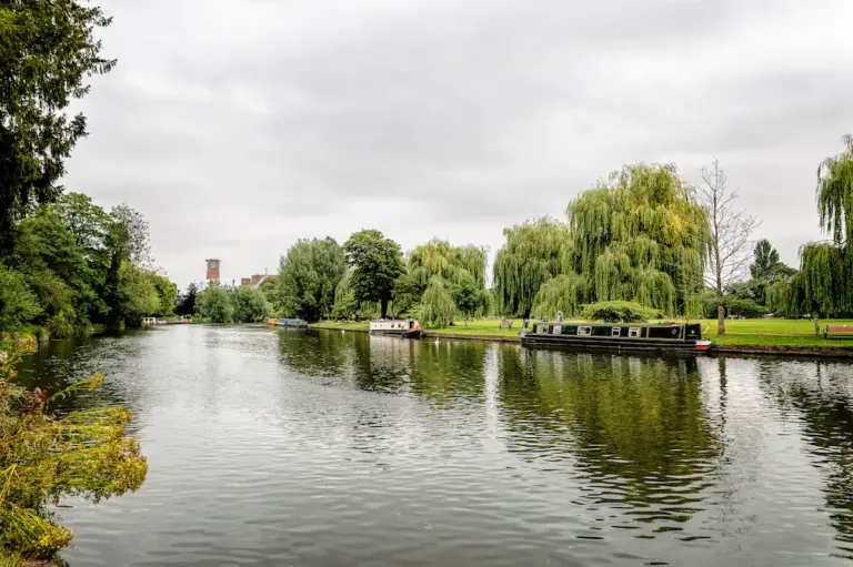 Avon River in Stratford-upon-Avon, UK. Cloudy day with tourists boats moored in riverside