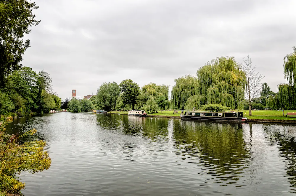 Avon River in Stratford Upon Avon, UK. Cloudy day with tourists boats moored in riverside